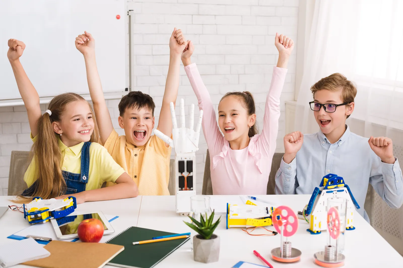Children cheering over the models they have built